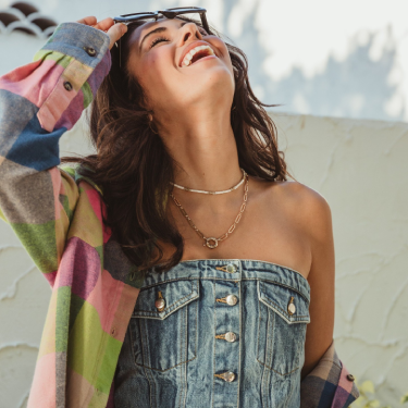 Woman laughing wear clothing from Buckle.