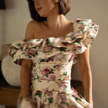 Woman wearing a floral-patterned dress from Dillard's.